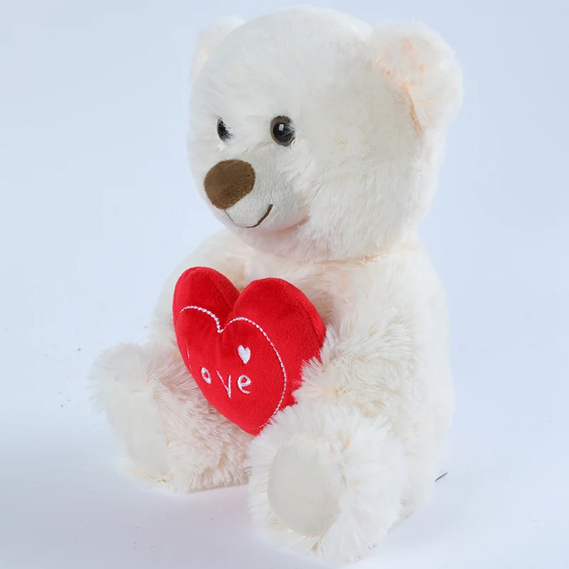 Ours blanc en peluche avec un coeur de profil Image