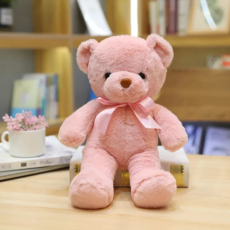 Ours rose clair en peluche couleur émotion sur une table