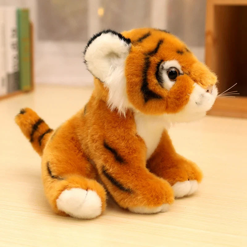Peluche bébé tigre orange assis sur une table Image