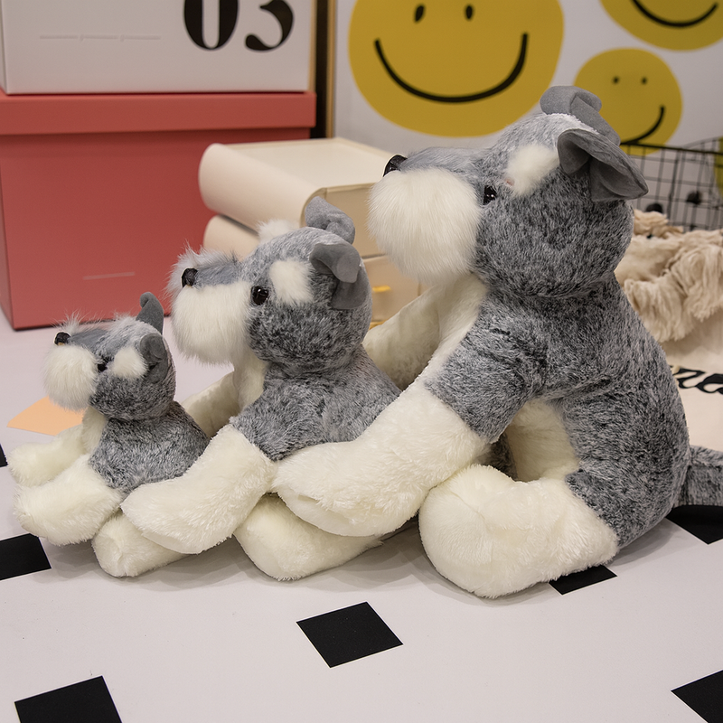 Trois peluches chiens Schnauzer sur le sol Image