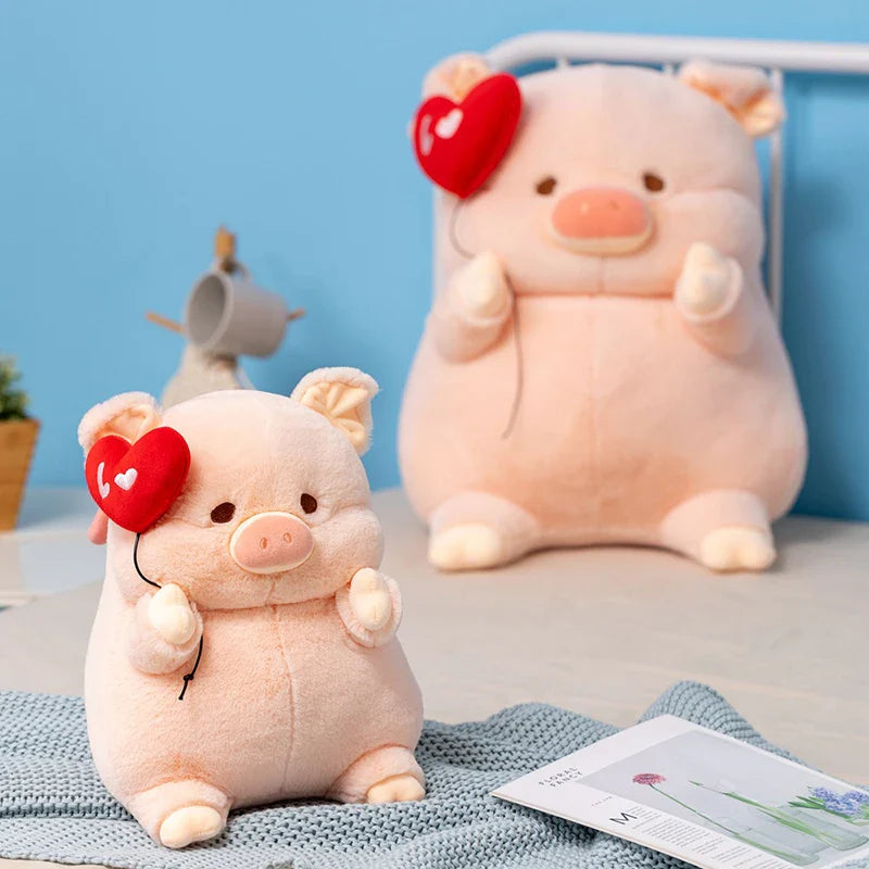 Deux peluches cochons amoureux dans un lit  Image