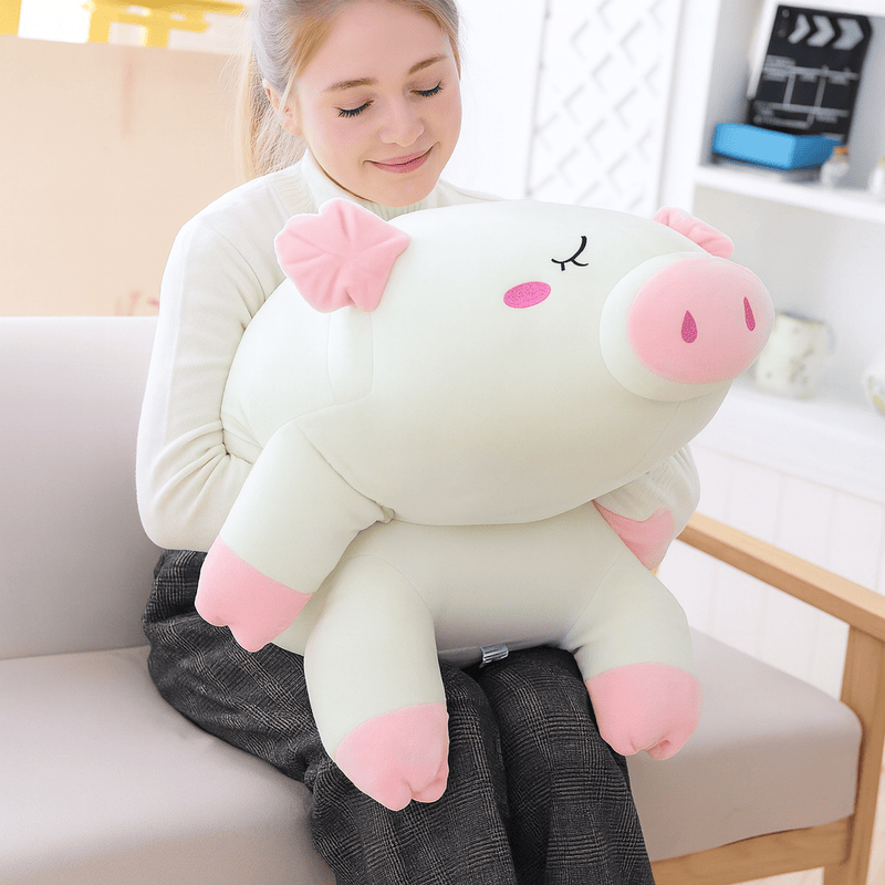 Peluche cochon blanc endormi sur une fille Image