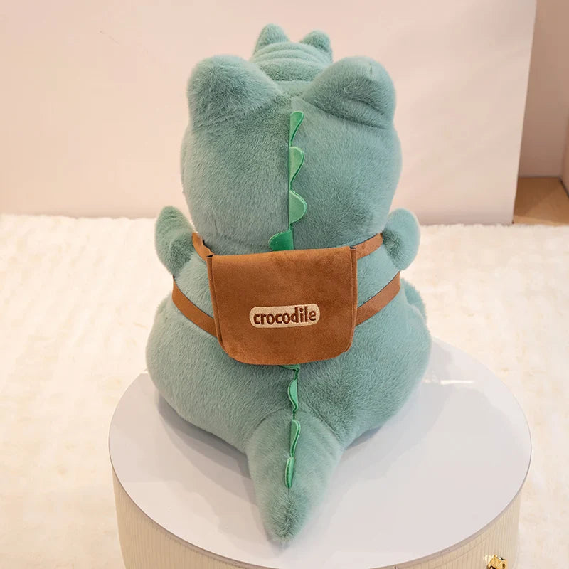 Peluche crocodile écolier de dos avec son sac à dos