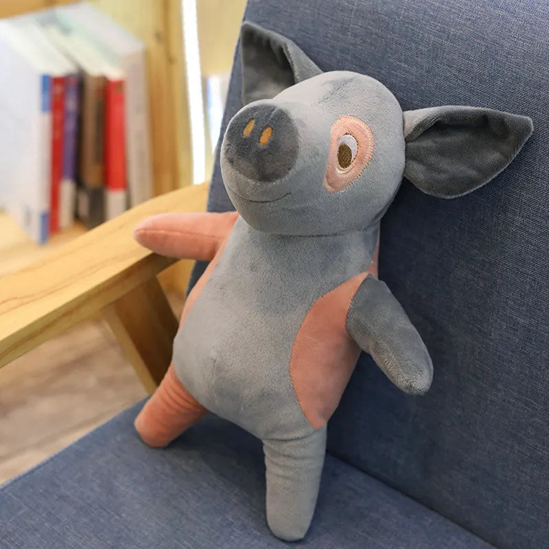 Peluche des petits cochons gris sur un fauteuil Image