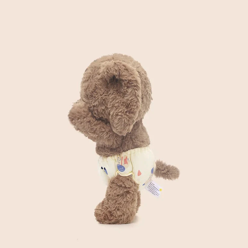 Peluche éléphanteau debout de profil en se cachant les yeux