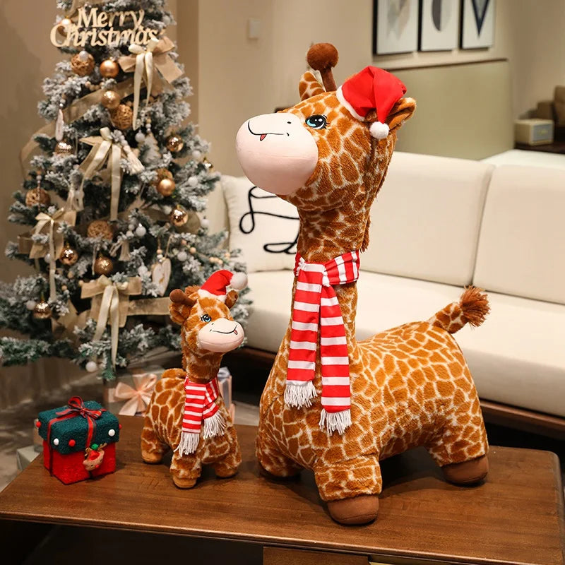 Deux peluches girafes de noël sur une table avec un cadeau à côté 