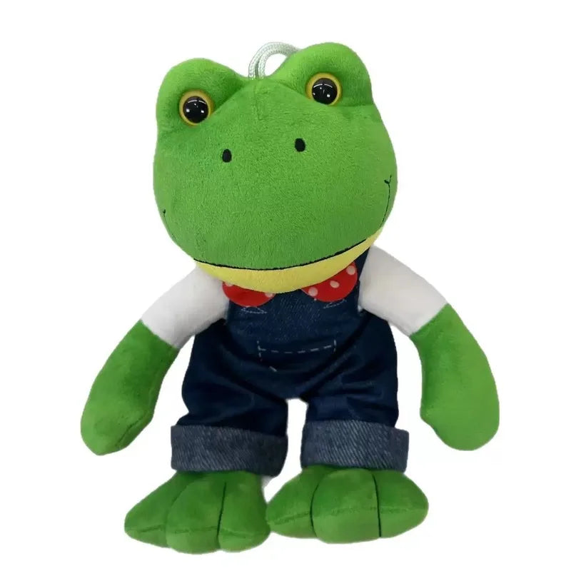 Peluche grenouille en salopette sur fond blanc