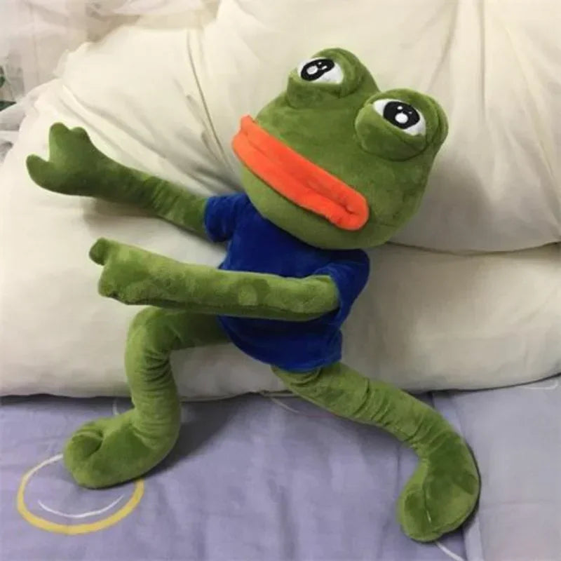 Peluche grenouille pepe Homme sur un lit  Image