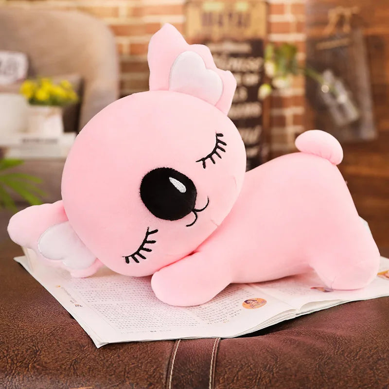 Peluche koala rose endormi sur un livre Image