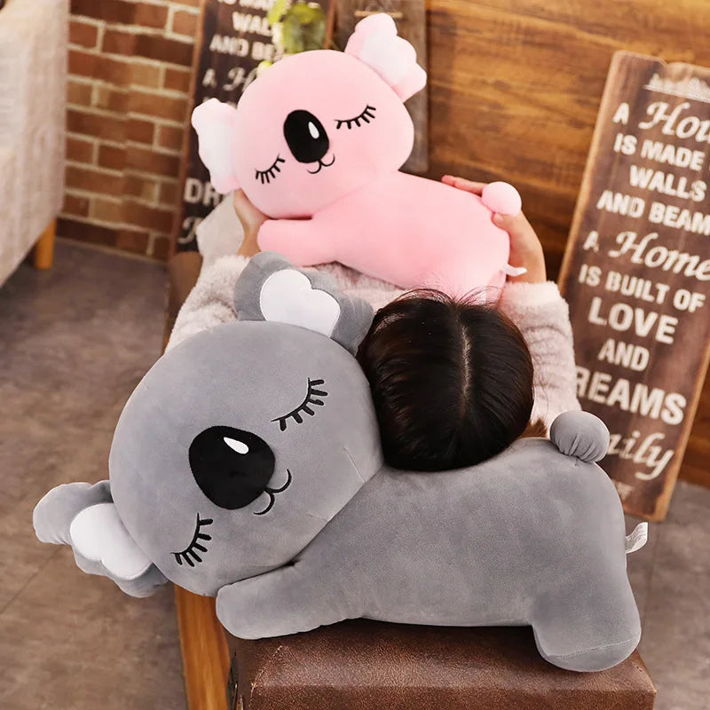 Deux peluches koala endormi sur un canapé sur une fille Image