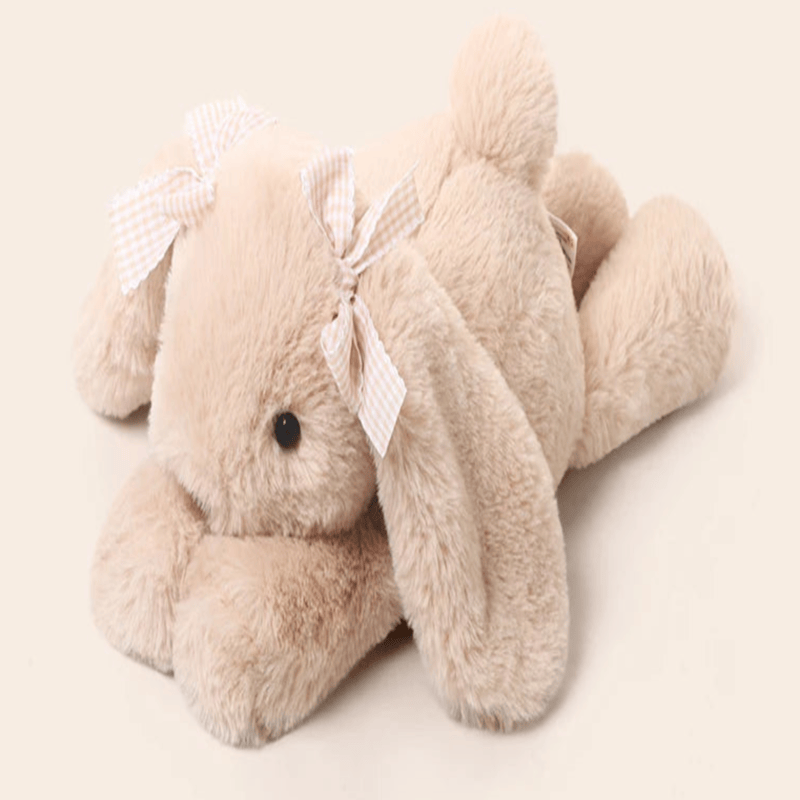 Peluche lapin couché sur fond blanc