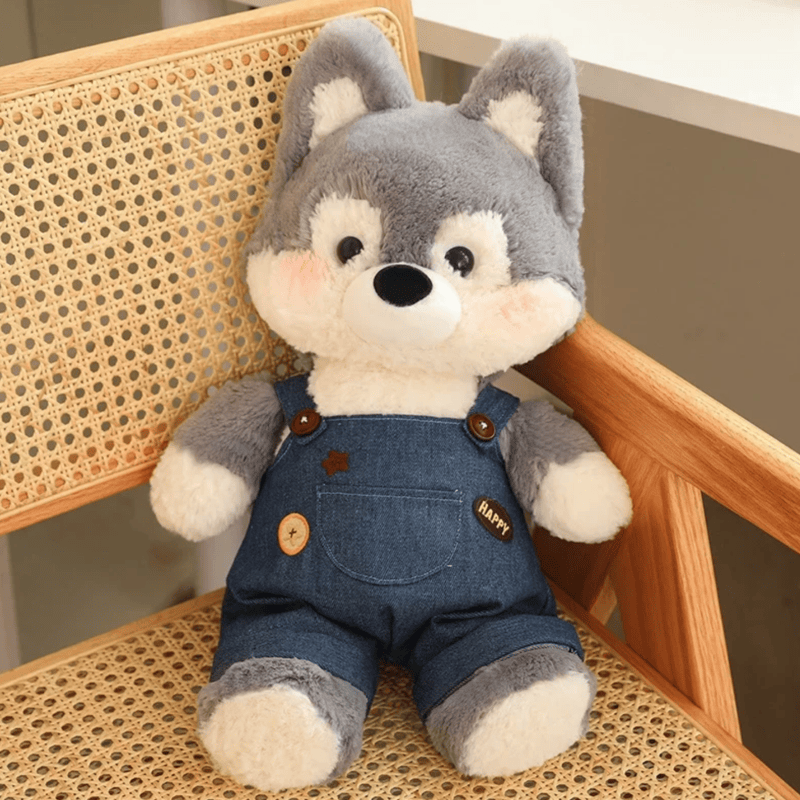 Peluche loup habillé sur une chaise Image