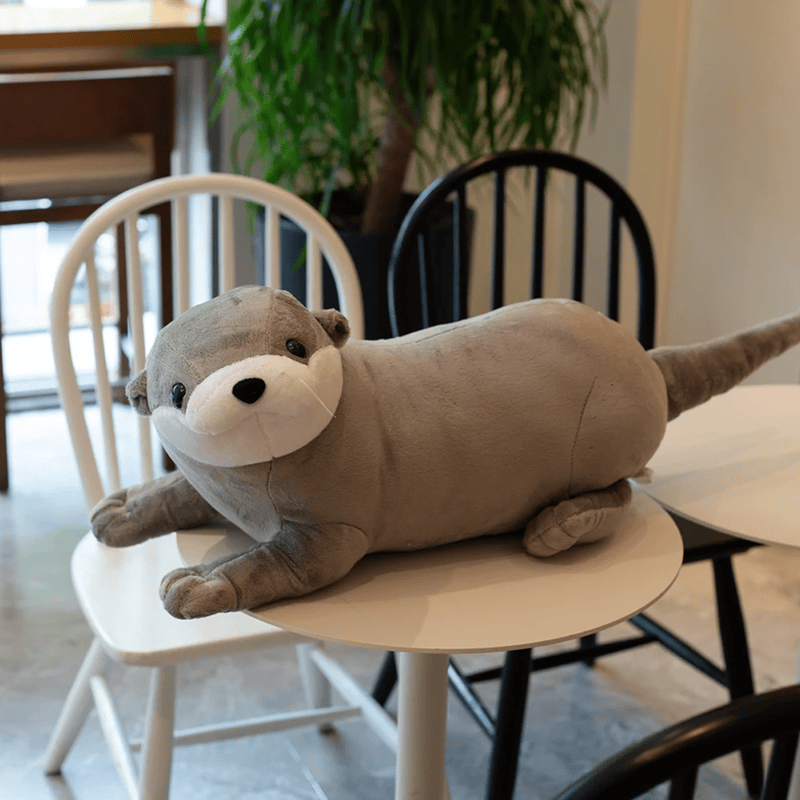 Peluche loutre grise sur une table