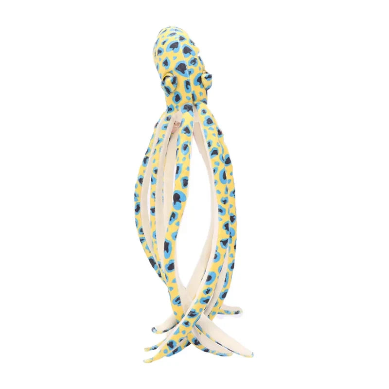 Peluche pieuvre à pois jaune sur un fond blanc