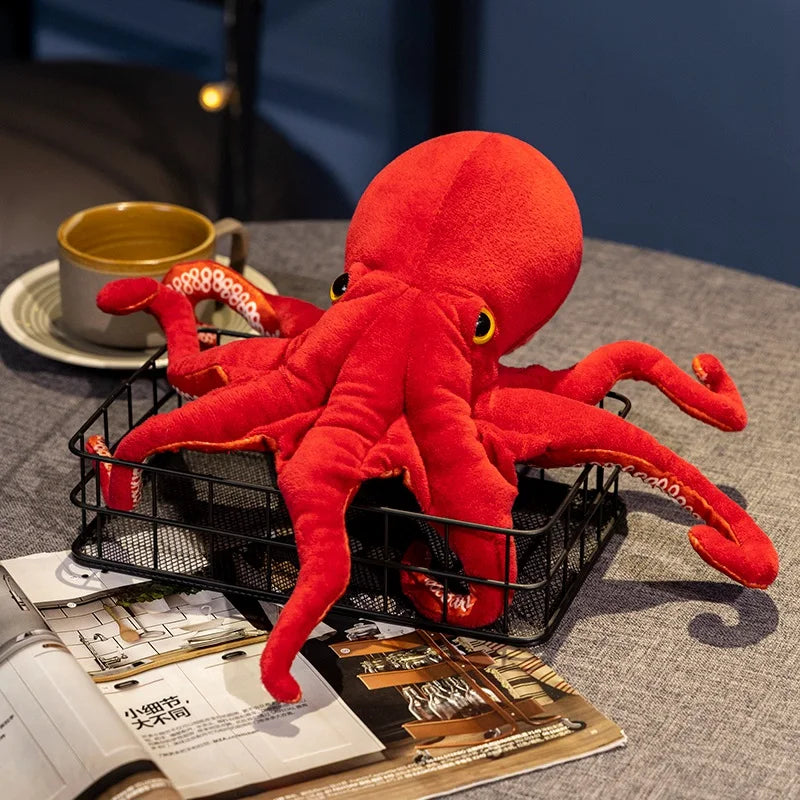 Peluche pieuvre rouge sur une table