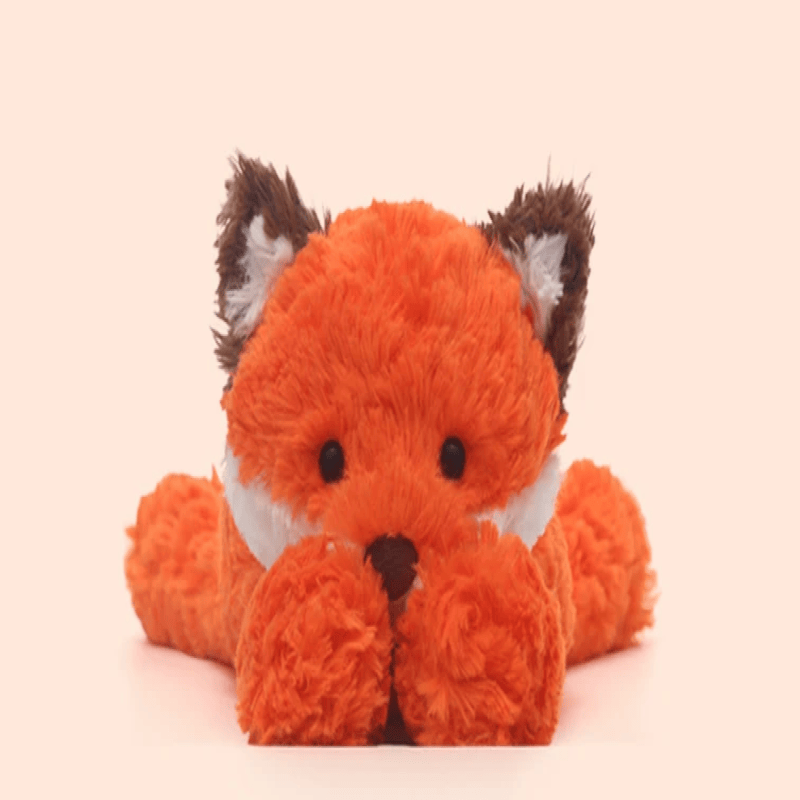Peluche renard japonaise cachottière sur fond beige  Image