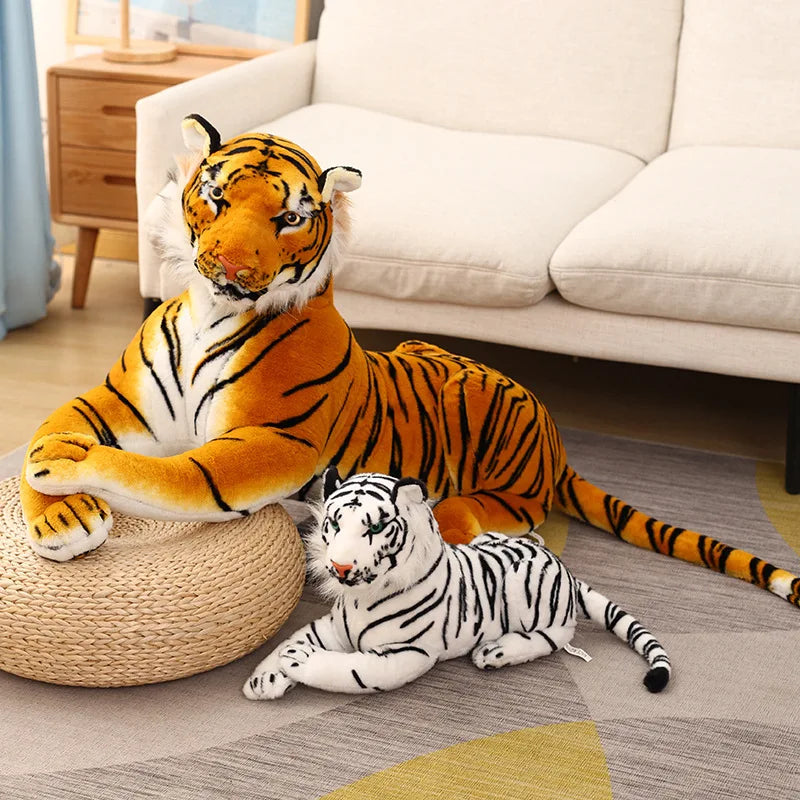 Deux peluches tigres allongés sur un tapis 