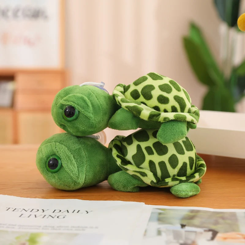 Deux peluches tortues aux gros yeux se chevauchent sur un meuble Image