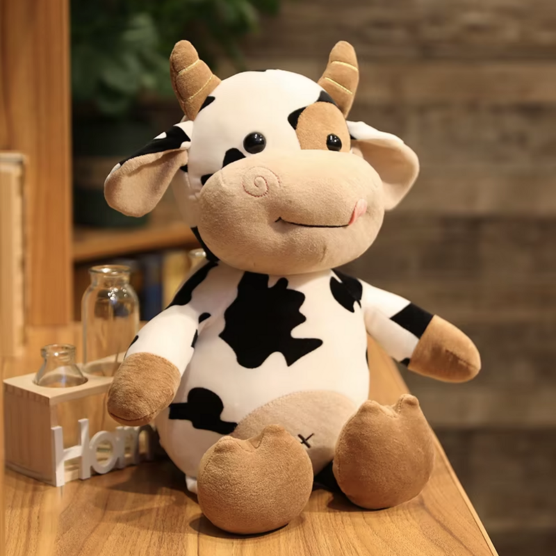 Peluche vache sans son sac sur un meuble