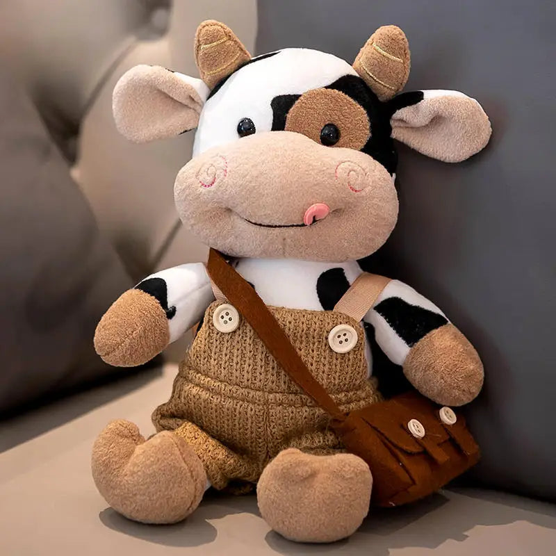 Peluche vache avec son sac sur un canapé