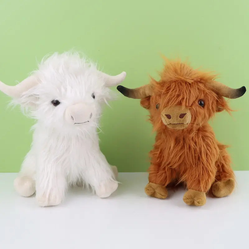 Deux peluches vaches highland sur fond vert