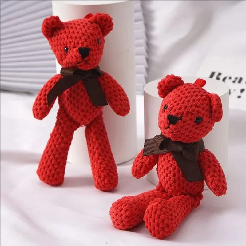 Deux ours rouges en peluches au crochet sur un canapé