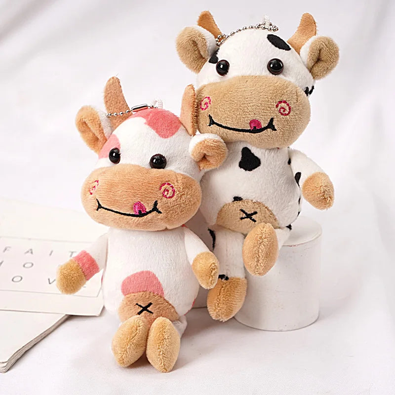 Deux petites vaches assises sur un bureau Image