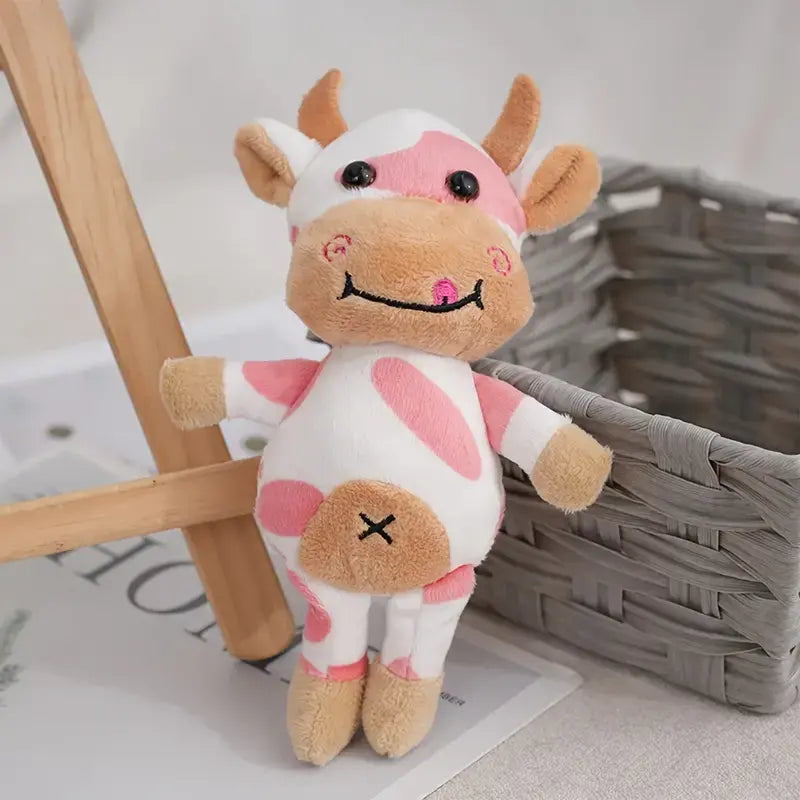 Petite peluche vache rose debout sur un tapis